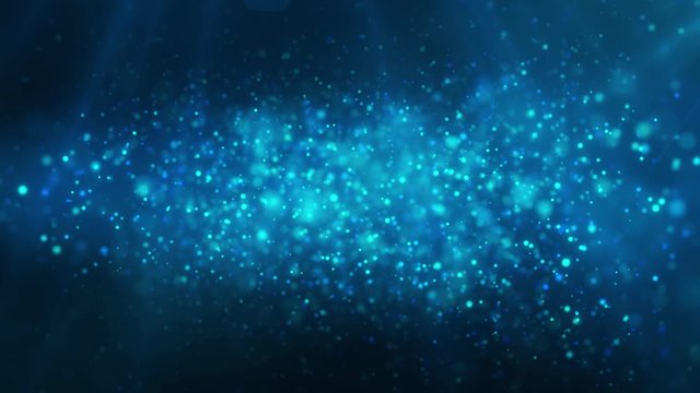 Blue shiny glowing glitter background. Dust, particles blue, cyan colored on dark background. Christmas, festive, greeting pattern.