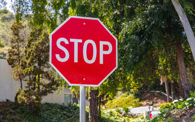 Stop sign against blue sky background. Sunny spring day