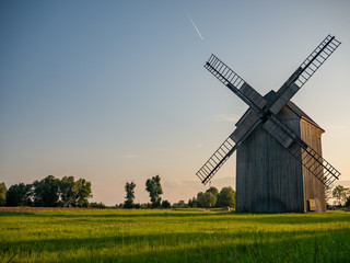 Fototapeta na wymiar Old windmill on the green field.