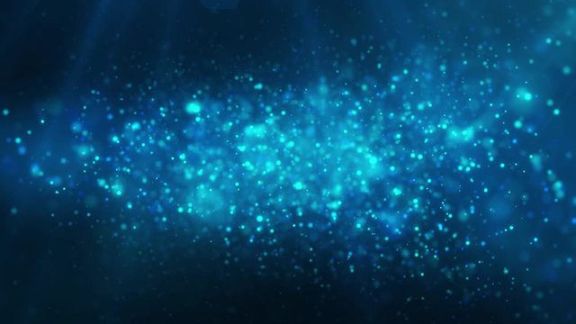 Blue shiny glowing glitter background. Dust, particles blue, cyan colored on dark background. Christmas, festive, greeting pattern.