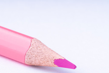 close up of pink pencil on white background .
