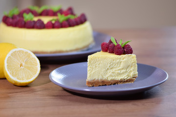 Slice of New York Cheesecake decorated with fresh raspberries.