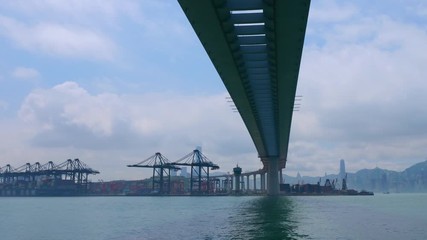 Time lapse of industrial port with containers ship in the harbor at Hong Kong city