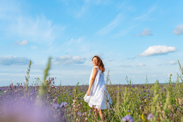 girl in a field of buckwheat. girl in white dress. girl in the harvest field