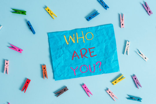 Word writing text Who Are You question. Business photo showcasing asking demonstrating identity or demonstratingal information Colored clothespin rectangle shaped reminder paper light blue background