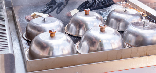 frying meat for burgers on the street