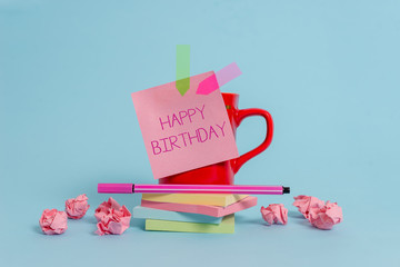 Writing note showing Happy Birthday. Business concept for The birth anniversary of a demonstrating is celebrated with presents Coffee cup pen note banners stacked pads paper balls pastel background