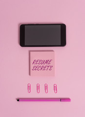 Text sign showing Resume Secrets. Business photo showcasing Tips on making amazing curriculum vitae Standout Biography Colored blank sticky note clips smartphone pen trendy pastel background