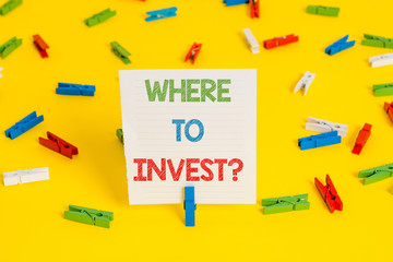 Conceptual hand writing showing Where To Invest question. Concept meaning asking about actions or process of making more money