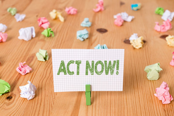 Conceptual hand writing showing Act Now. Concept meaning do not hesitate and start working or doing stuff right away Colored crumpled papers wooden floor background clothespin