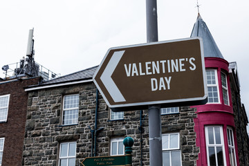 Naklejka premium Text sign showing Valentine S Day. Business photo showcasing time when showing show feelings of love and affection Empty street signs on the crossroads with blank copy space