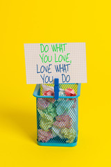 Text sign showing Do What You Love Love What You Do. Business photo showcasing you able doing stuff you enjoy it to work in better places then Trash bin crumpled paper clothespin empty reminder office