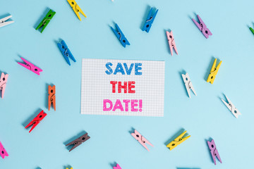 Handwriting text writing Save The Date. Conceptual photo Organizing events well make day special event organizers Colored clothespin rectangle shaped reminder paper light blue background