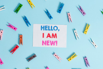 Handwriting text writing Hello I Am New. Conceptual photo used as greeting or to begin telephone conversation Colored clothespin rectangle shaped reminder paper light blue background