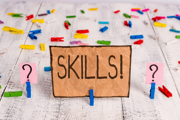Conceptual hand writing showing Skills. Concept meaning ability do something very well by nature Crumbling sheet with paper clips placed on the wooden table