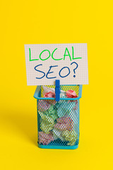 Text sign showing Local Seoquestion. Business photo showcasing incredibly effective way to market your local business online Trash bin crumpled paper clothespin empty reminder office supplies yellow