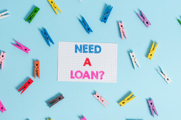 Handwriting text writing Need A Loan question. Conceptual photo amount of money that is borrowed often from bank Colored clothespin rectangle shaped reminder paper light blue background