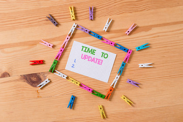 Writing note showing Time To Update. Business concept for act updating something someone or updated version program Colored clothespin papers empty reminder wooden floor background office
