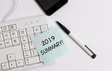 Handwriting text writing 2019 Summary. Conceptual photo summarizing past year events main actions or good shows White pc keyboard with empty note paper above white background