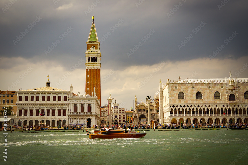 Wall mural venice, italy - july,5: stormy day in the center of venice, boats, buildings, bridges under the heav