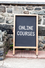 Handwriting text writing Online Courses. Conceptual photo Revolutionizing formal education Learning through internet Empty black board with copy space for advertising. Blank dark board