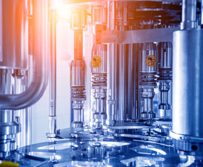 Automatic filling machine pours water into plastic PET bottles. Brewing production.