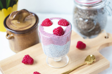 Chia pudding with almond milk, yogurt, pitaya powder and raspberries. Vegan concept.