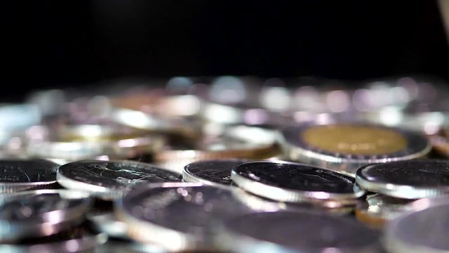 Slow motion close up falling coin on black background (Thai currency, THB coin)