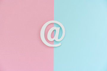 Email symbol on blue and pink background. Concept for email, communication or contact us