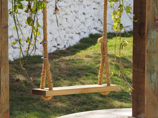 Close-up of a swing hanging on the beach in a restaurant.