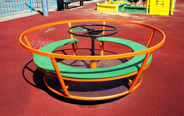  Children's little carousel in the playground.