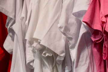 Things on storefront. Shop with new clothes. Suits hang on hangers.