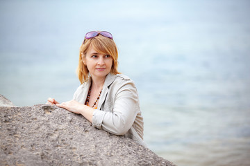Portrait of a young woman on the background of the sea