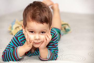 Portrait little boy on bed