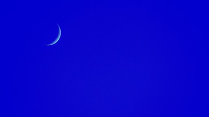 Blue sky with new moon