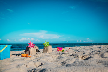 sand toys and castle on tropical beach, kids play on sea vacation