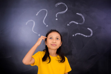 Female student looking at question marks