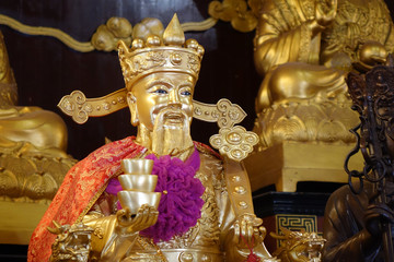 God of Wealth (Cai Shen) : Golden Taoist gods sculpture in Taoism temple. Selective focus.
