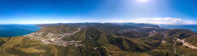 Fototapeta na wymiar mountains near the city of Tuapse and the resort village of Agoy on the Black Sea coast - aerial drone large panorama view from a mountain pass in summer sunny day
