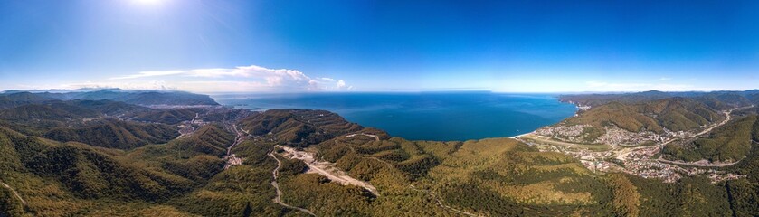 Tuapse city and the resort village of Agoy on the Black Sea coast - aerial drone large panorama view from mountain pass in summer sunny day