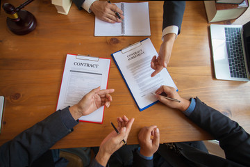 Group of business people and lawyers discussing contract papers ,Consultation between a male lawyer...