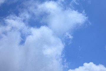 Clouds were floating in the blue sky.