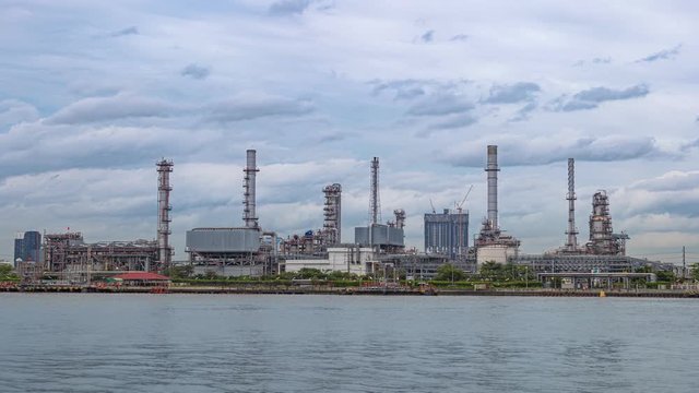 4K (3840p) A close-up of energy industry with blue sky background, timelapse technology production of petrol chemical at twilight, Grobal warming background is save energy and environment concept.