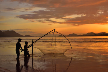 People fishing in river brahmaputra during sunset.
