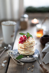 Sweet pancakes with currant berries and honey