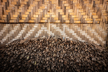 wood pile beside a bamboo wall