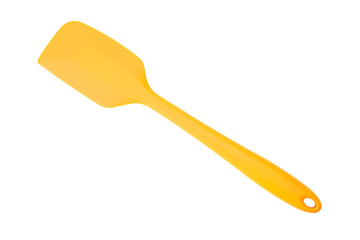 Orange silicone kitchen spatula for cooking isolated on white background with selection path.