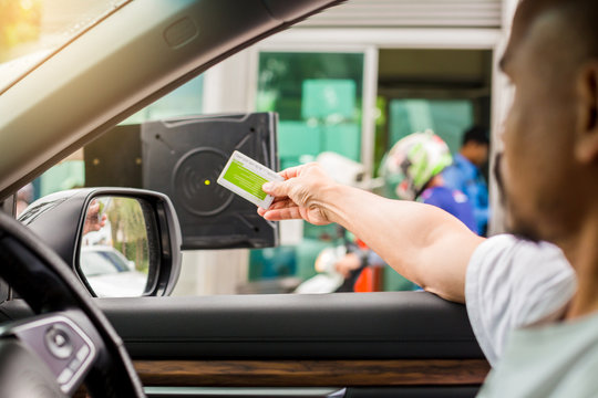 Selective Focus To Driver Hold Card To Scan At Card Reader Station For Open The Car Park Door. Stop Car And Use Key Card To Open The Door For Safety. Security System For Parking. The Security Concept.