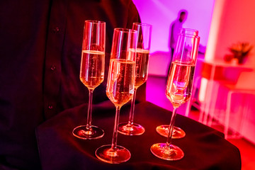 glasses of champagne on red background