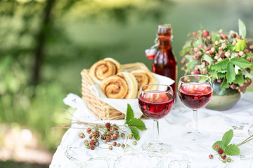 Breakfast in the garden: buns, juice from fresh strawberries